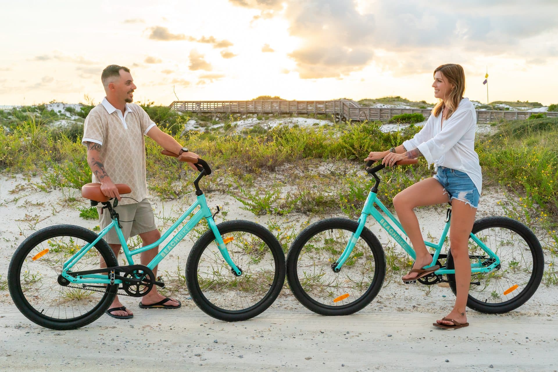 Couple with Beach Bikes on the dunes at sunset